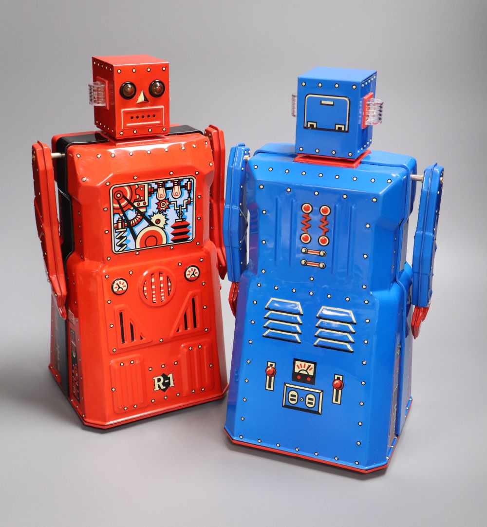 Rocket USA, a rare limited edition 2001 Red R-1 Robot with Black Band, No. 15/34 and a blue version of the R-1 Robot,